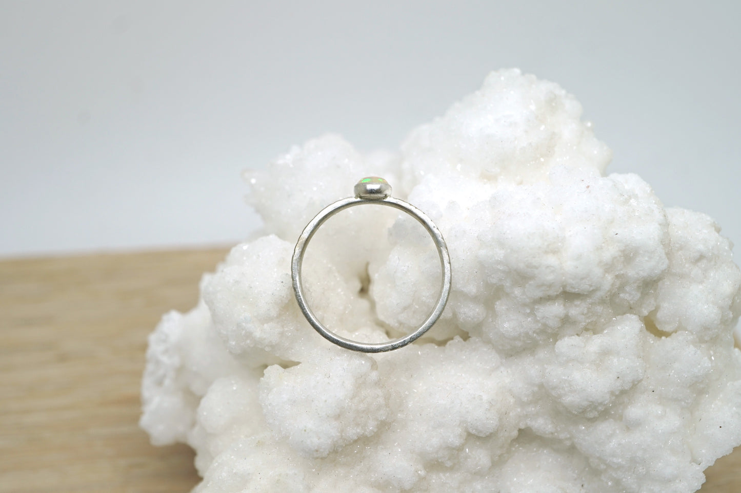 Opal ring with hand-carved feather textures