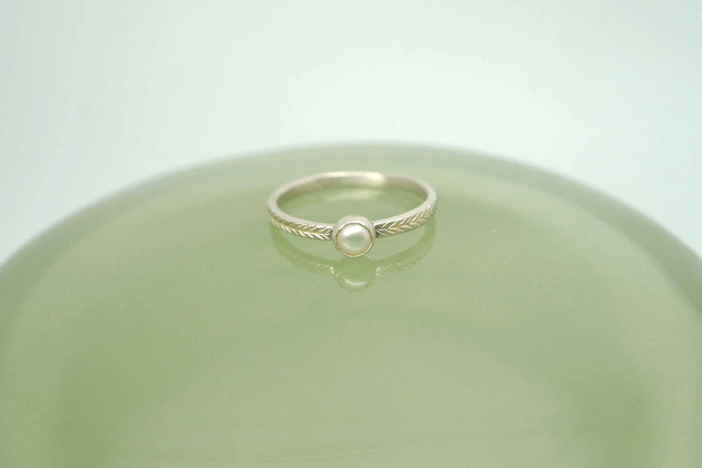 Pearl ring with hand-carved feather textures