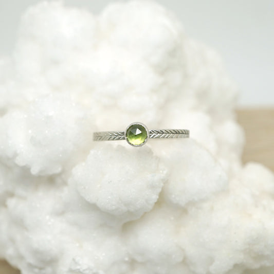 Peridot ring with hand-carved feather textures