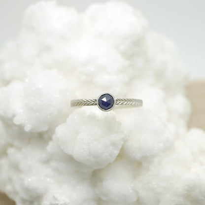 Sapphire ring with hand-carved feather textures