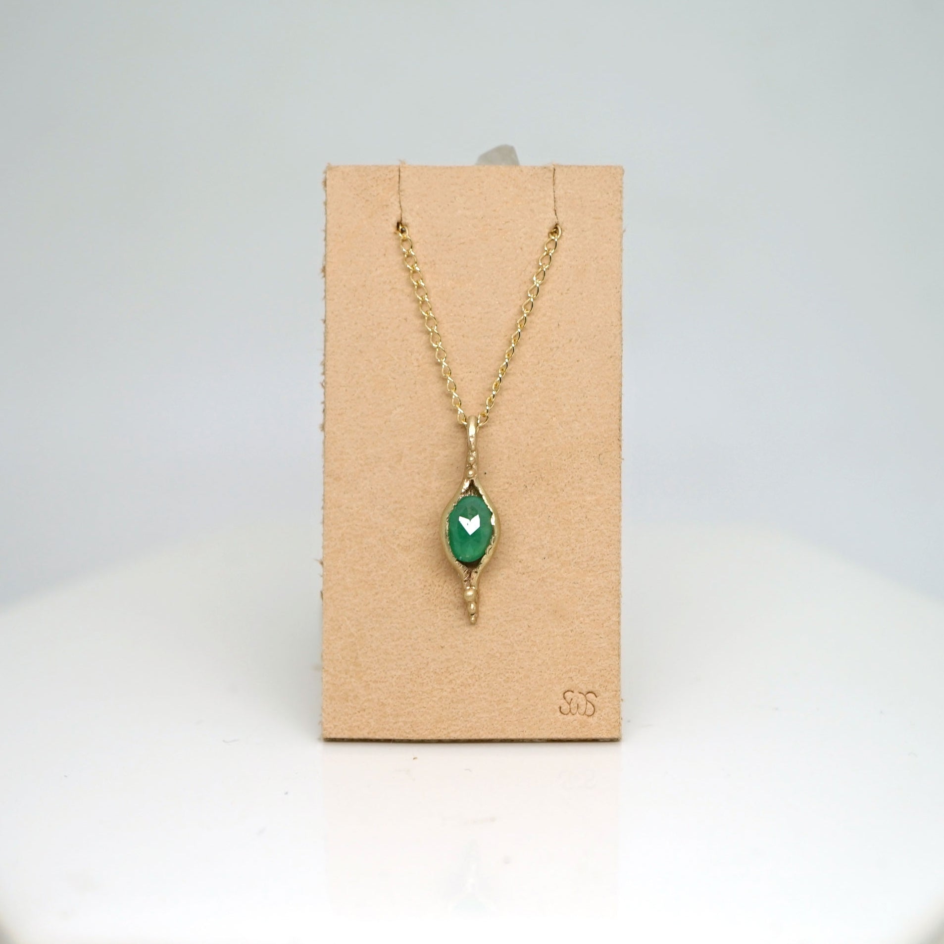 Pod pendant necklace with emerald