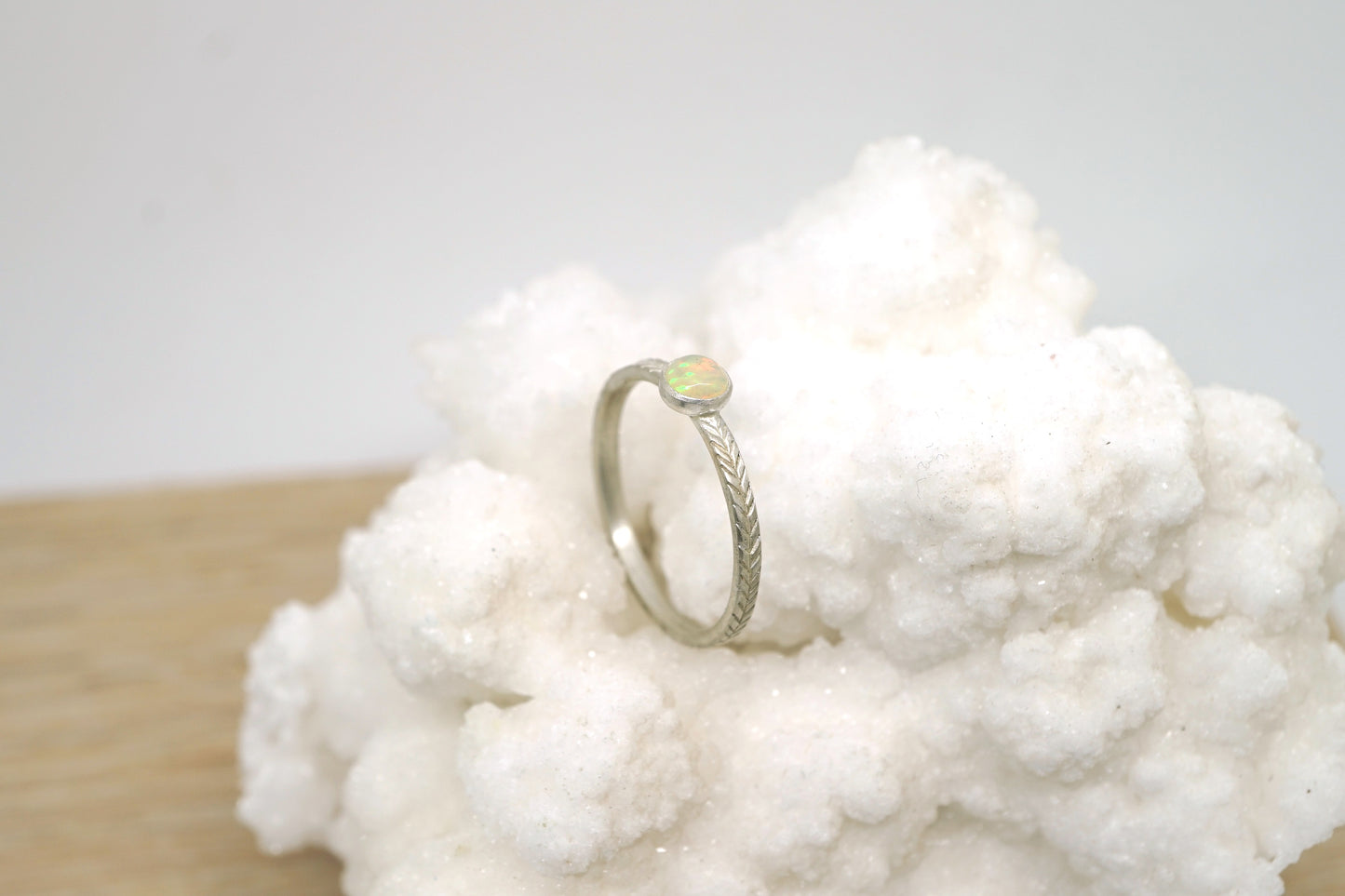 Opal ring with hand-carved feather textures