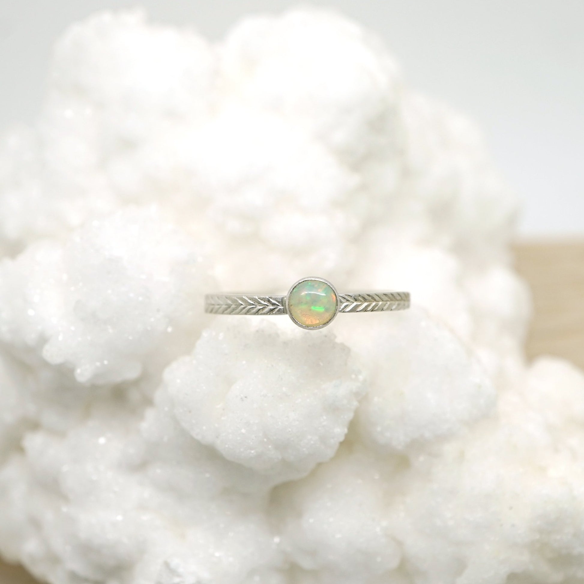 Opal ring with hand-carved feather textures