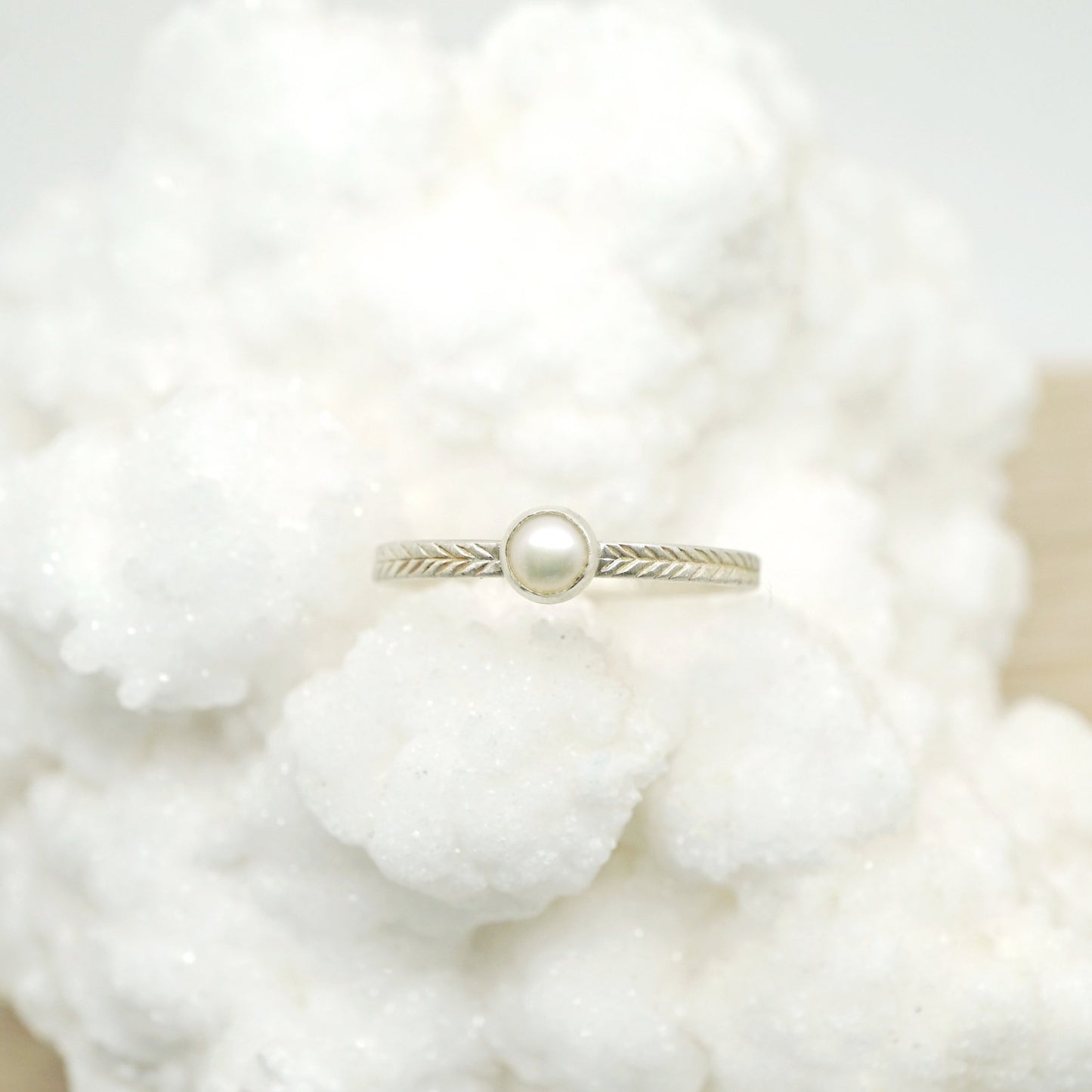 Pearl ring with hand-carved feather textures